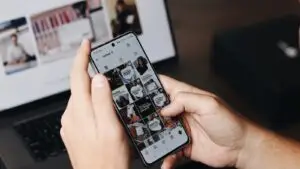 A small business owner reviews their Instagram profile and Reels performance on a smartphone.