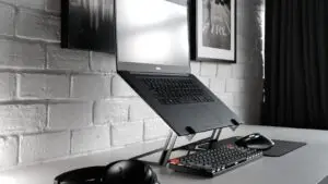 Small business owner reviewing a marketing dashboard on a laptop during a video call with a remote team