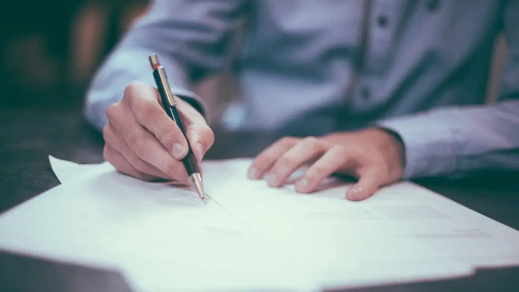 Small business owner reviewing the key clauses of a marketing agency contract before signing