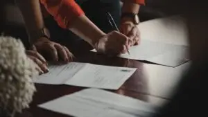 Small business owner comparing marketing agency pricing proposals at a desk