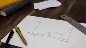 Small business owner reviewing revenue and lead numbers to decide when to hire a marketing agency